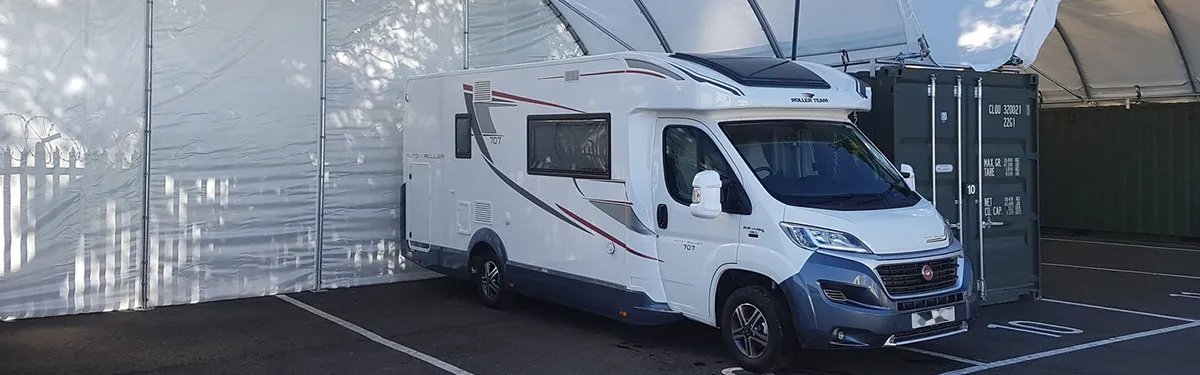 Motorhome parked in a covered storage bay