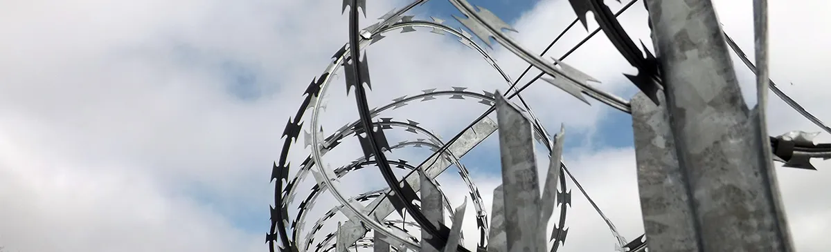 Razor wire topping the perimeter fence